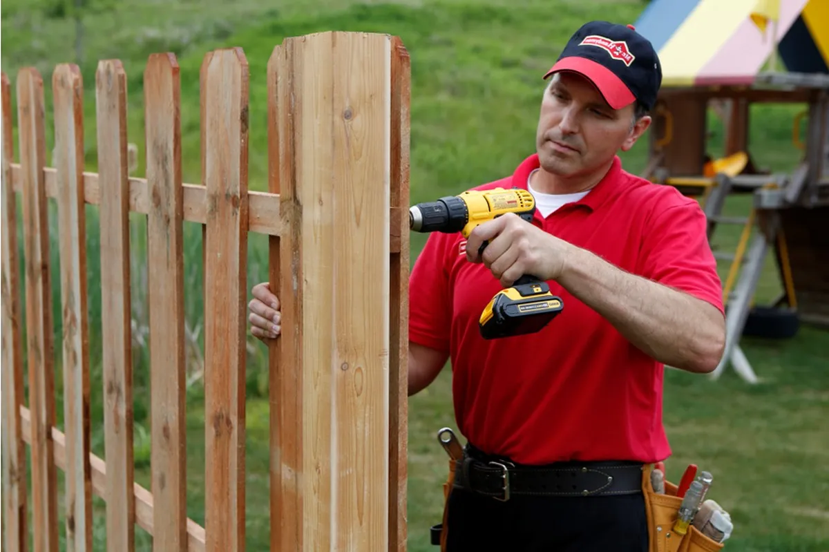 Mr. Handyman technician repairing fence in Boulder, CO.