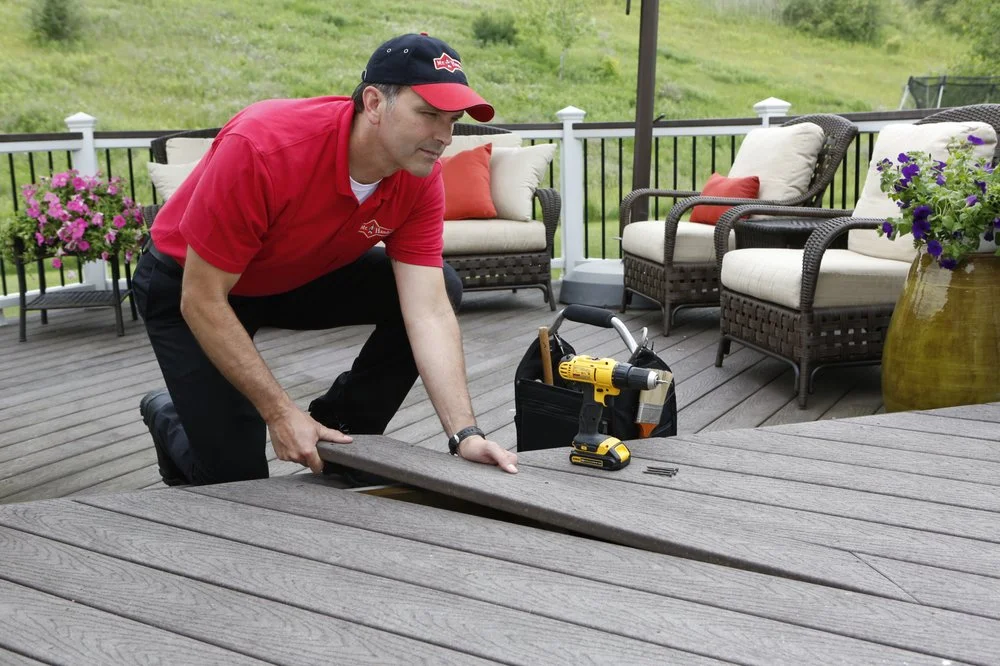 A Mr. Handyman technician installing a new piece of decking.