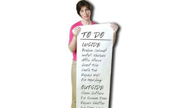 A woman holding a sign that says to do inside.