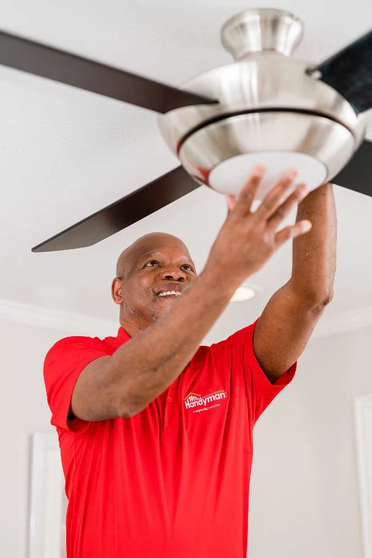 Handyman completing a Mr. Handyman ceiling fan installation.