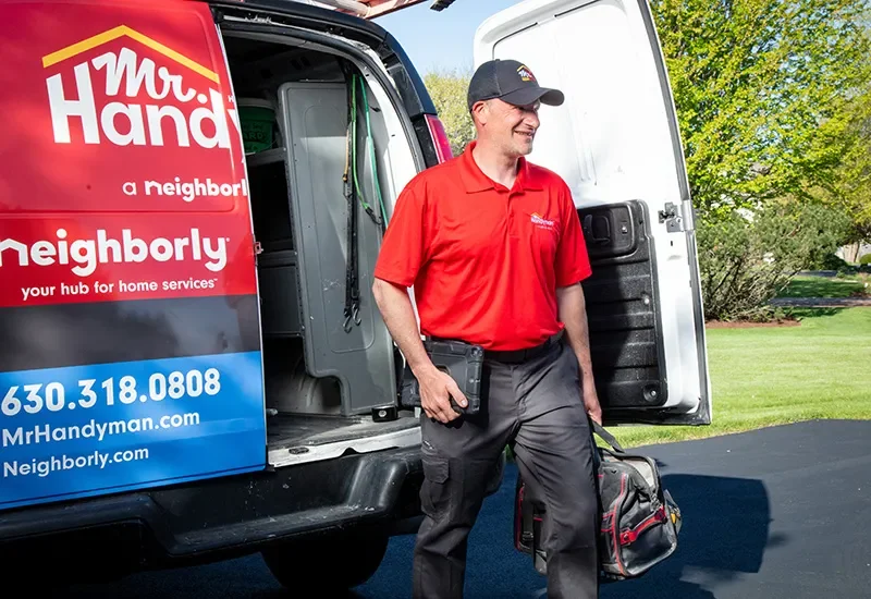 Mr. Handyman professional arriving to repair a customer's door.