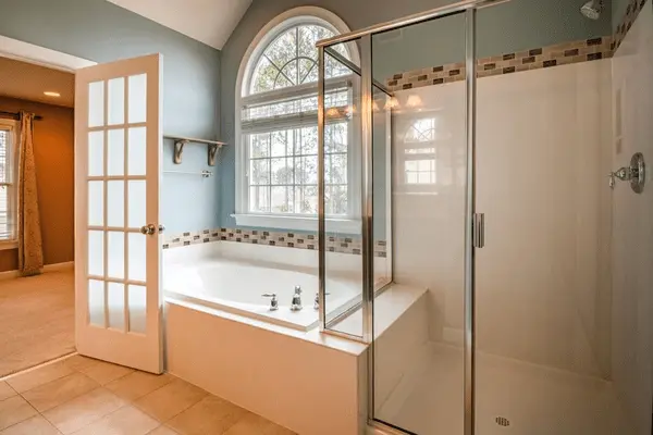 A wide view of a chic bathroom, including a clear shower door