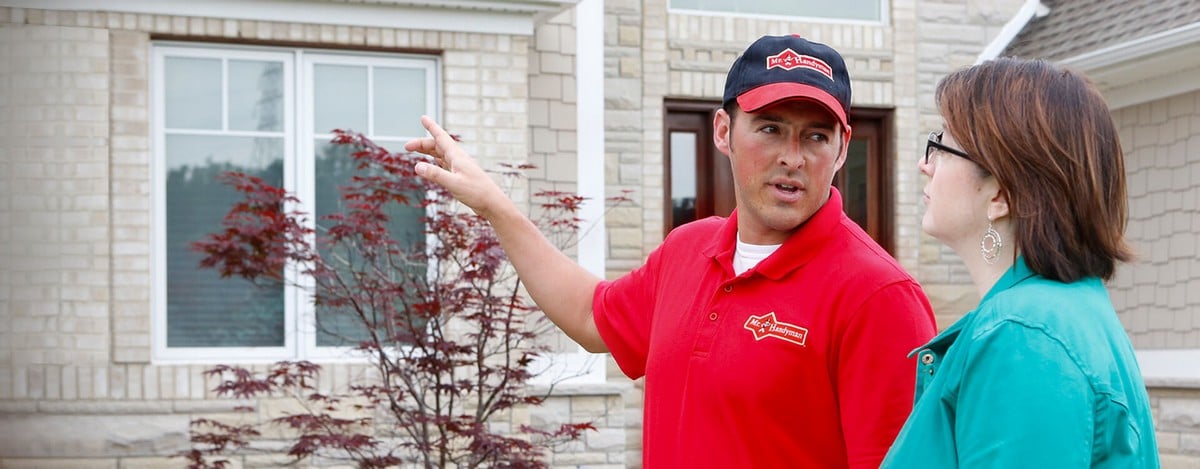 A Wood River handyman explaining exterior home repairs to a homeowner.