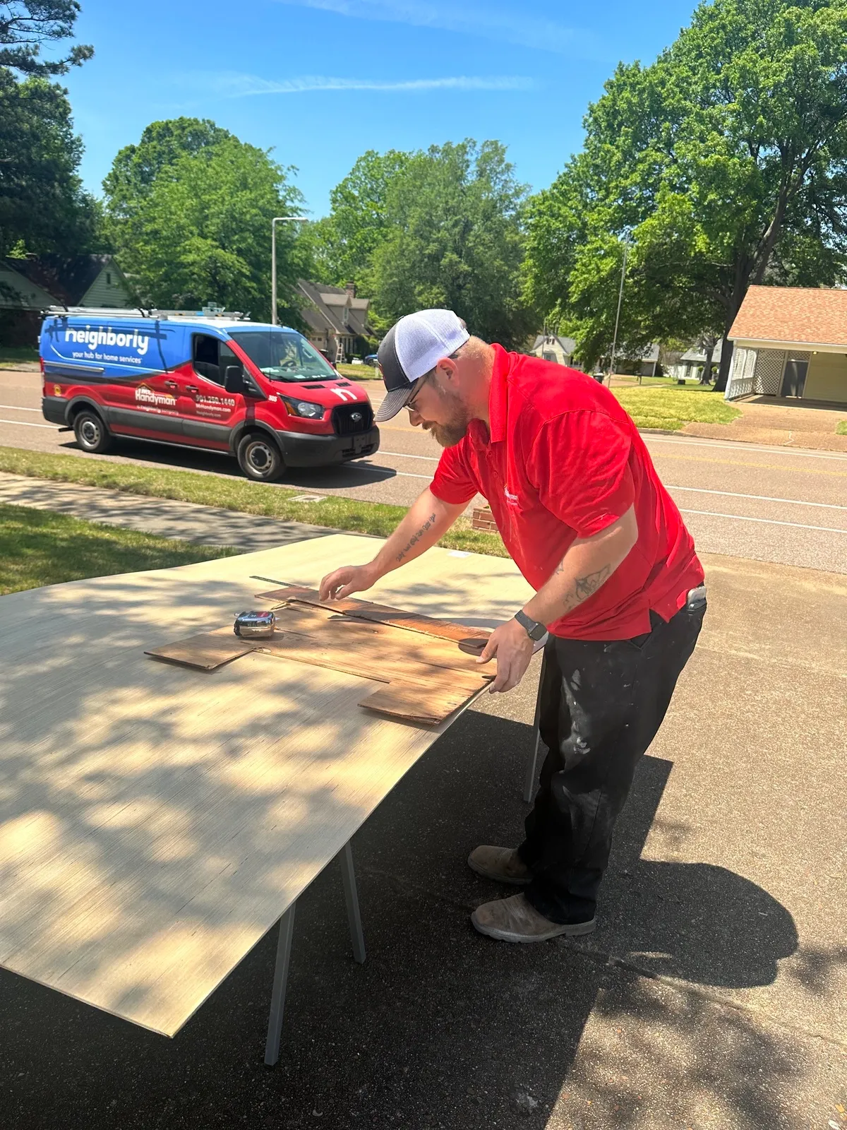 Collierville handyman preparing wood panels on a client’s property