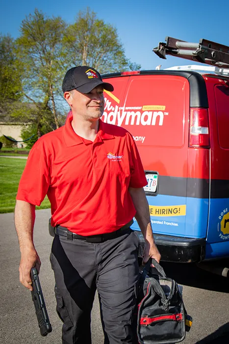 Mr. Handyman tech arriving to perform debris removal at a residence.