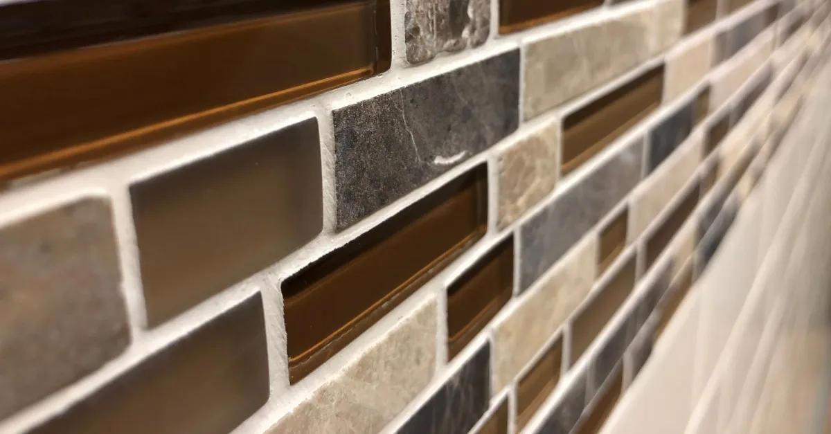 A kitchen backsplash made of brown tiles put in place by a handyman during an appointment for backsplash installation in Walpole, MA.
