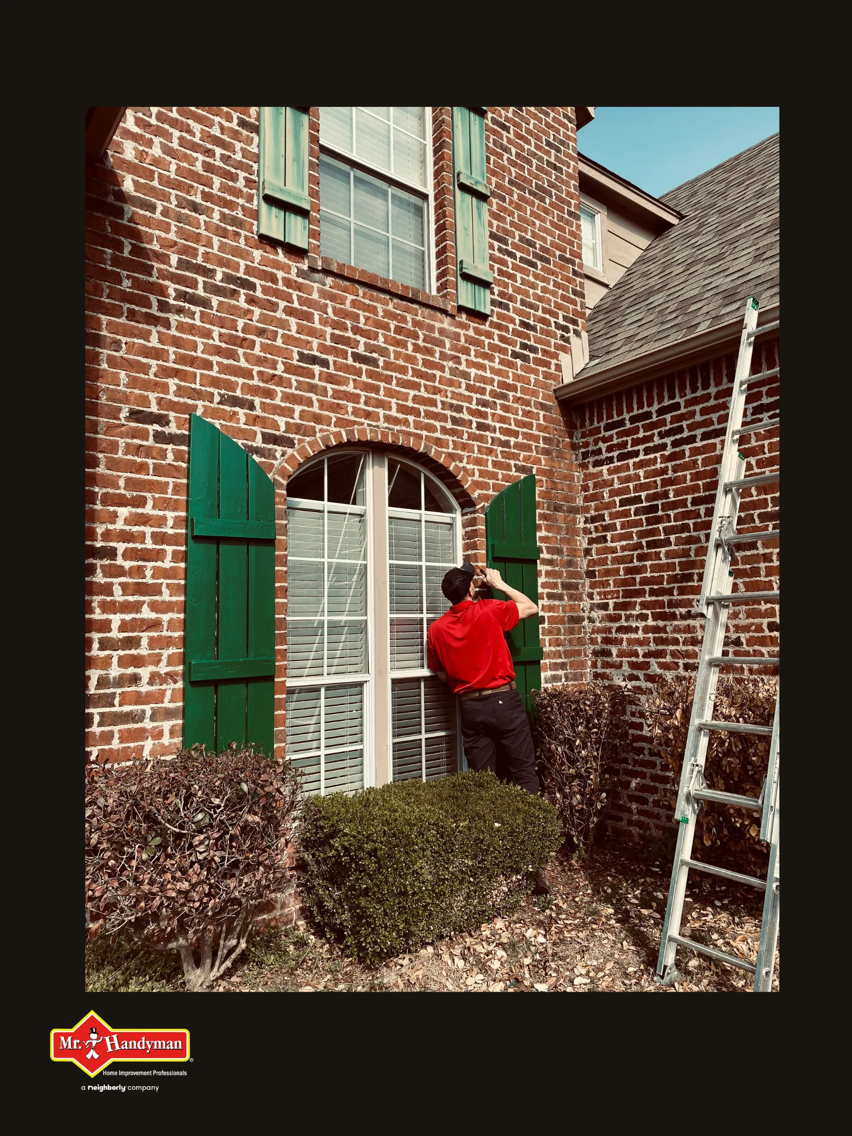 A handyman examining a tall window’s shutters during an appointment for window repair in Tulsa, Oklahoma.