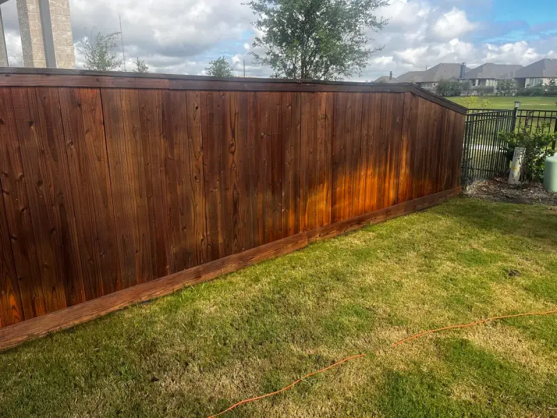 Fence staining completed by Mr. Handyman during fence repair in Richmond, TX.